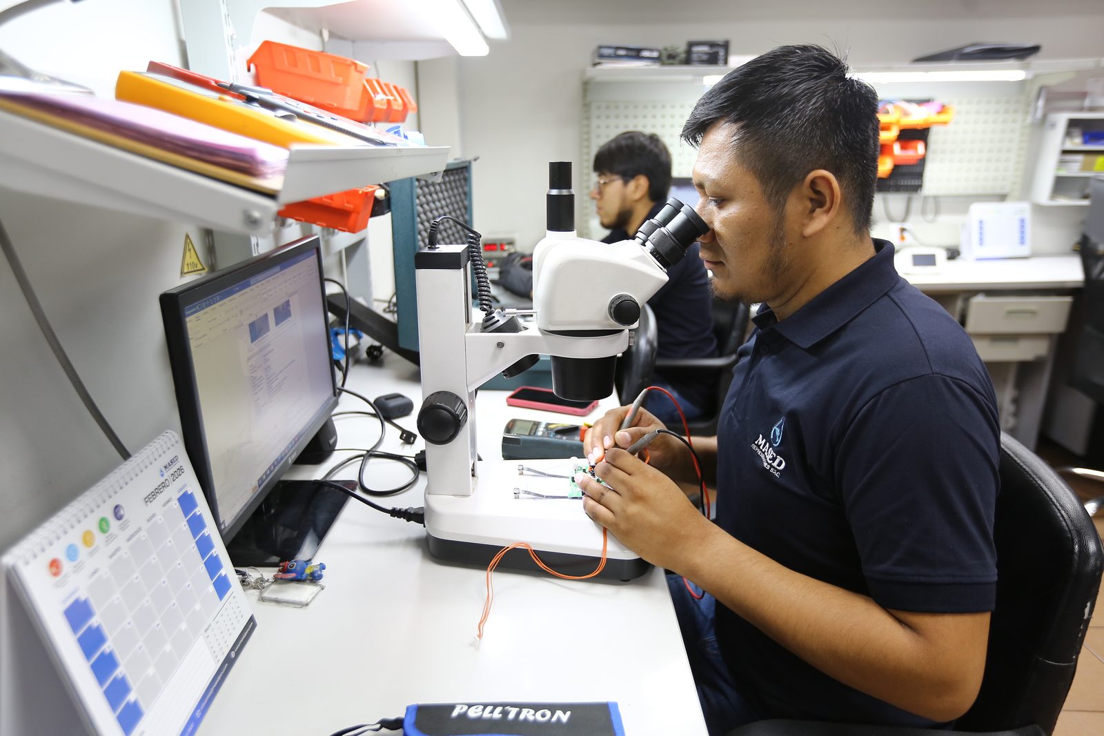 Equipo técnico de Mased realizando revisión con microscopio en laboratorio